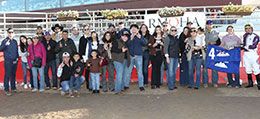 The winning connections of Presido Pete accept the Lucile Rowe Derby stakes trophy Sunday at Arapahoe Park.