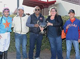 The winning connections of Rayenare accept the La Fiesta Derby stakes trophy on Sunday.