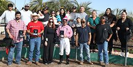 The winning connections of Sweet Fire Wes accept the $61,880 AQRA Quarter Horse Futurity trophy at Turf Paradise on Monday.