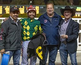 The winning connections of Kevins Wise Corona accept the First Down Dash Handicap trophy at Los Alamitos on Saturday.