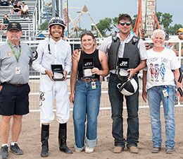 The winning connections of Ca Mental accept the Charles M. Russel Futurity stakes buckles.
