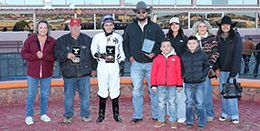 The winning connections of Boot Scoots accept the $80,000 Red or Green Stakes (RG2) trophy at Sunland Park on Saturday.