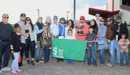 The winning connections of Electrifying Cowboy accept the La Fiesta QH Futurity stakes trophy at The Downs at Albuquerque.