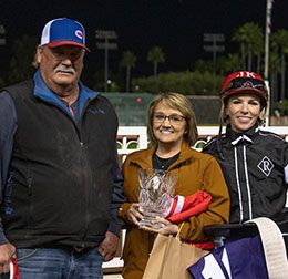 Trainer Eddie Willis, Paige Mays and jockey Justine Klaiber accept the Brad McKenzie Winter Championship stakes trophy.
