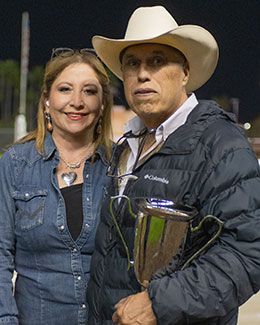 Owners Oscar Jaiver Diaz and Luz Ayala Diaz with the Azure Three Handicap stakes trophy.