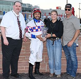 The winning connections of Relentless Rocket accept the Altoona Derby trophy at Prairie Meadows on Friday.