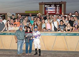 The winning connections of Relentless Legacy accept the Bob Morehouse Stakes trophy on Thursday at Canterbury Park.