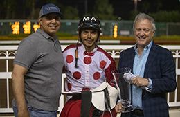 The winning connections of Cattail Cove accept the $40,000 Kaweah Bar Handicap trophy at Los Alamitos on Saturday.