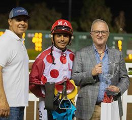 Trainer Juan Aleman, jockey Martin Arriaga, and owner Link Newcomb accept the Independence Day Stakes trophy.