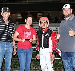 The winning connections of Ima Chili accept the Silver Bullet Stakes trophy at Retama Park.