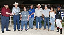 The winning connections of Princess Chenoa accept the $46,000 La Villita Stakes trophy at Retama Park on Thursday.