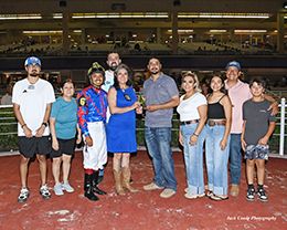 The winning connections of Jvm Hot Victoria accept the TBHBA Paint Horse Juvenile Stakes trophy at Retama Park on Thursday.