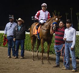 The winning connections of Project Leader accept the $35,000 Summer Stakes trophy at Los Alamitos on Sunday.