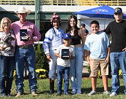 The winning connections of Two Two 22 accept the $53,014 Adequan Will Rogers Derby Challenge trophy at Will Rogers Downs on Sunday.