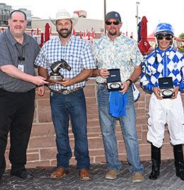 The winning connections of Foxy Cowgirl accept the Cox Ranch Prairie Meadows Distaff Challenge stakes trophy.