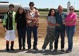 The connections of Escondido Gold accept the $30,500 QHRAI Stallion Service Auction Derby Invitational Stakes winning trophy at Horseshoe Indianapolis on Saturday.