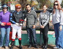 The winning connections of Jessaprimadonna accept the Wayne Brasher Memorial Stakes trophy at Turf Paradise.