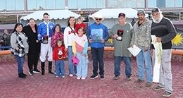 The winning connections of Alamos accept the $80,000 Pepsi Cola Stakes trophy at Sunland Park on Saturday.