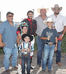 The winning connections of El Huracano V accept the Rainbow Futurity stakes trophy Sunday afternoon.