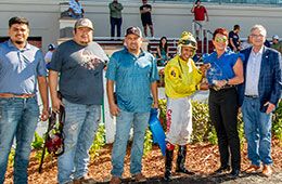 The winning connections of Hes A Bold Corona accept the De Saix Stakes trophy at Fair Grounds Race Course.