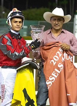 Winning jockey Armando Cervantes and trainer Ramiro Castillo accept the Vessels Maturity Stakes trophy at Los Alamitos Race Course.