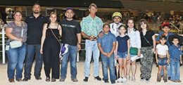 The winning connections of Mr Michel accept the Gary Baber Memorial Stakes trophy at Retama Park on Saturday.