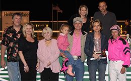 The connections of Cigaronthebeach accept the Julie Veltman Overnight Stakes winning trophy at Horseshoe Indianapolis on Thursday.