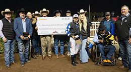 The winning connections of Lethal Cowboy 123 accept the Los Alamitos Two Million Futurity stakes trophy.