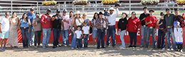 The winning connections of Kali K accept the $26,750 Leo Beau Dash Stakes trophy at Arapahoe Park on Saturday.