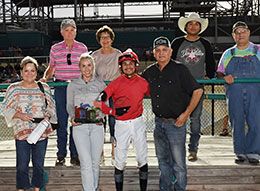 The winning connections of Og Flamingo accept the 79 and Under Speed Index Futurity stakes trophy.