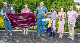 The winning connections of Last Eagle V accept the $399,104 Mardi Gras Futurity [RG2] trophy at Louisiana Downs on Saturday.