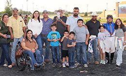 The winning connections of Handsomer accept the TPHBA Maiden Juvenile stakes trophy at Lone Star Park.