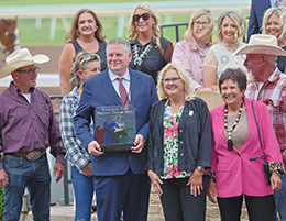 The winning connections of Wynchester accept the Remington Park Distance Championship stakes trophy on Saturday.