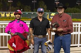 The winning connections of Cmhowabouthemcowboy accept the $34,782 Adequan California Derby Challenge trophy at Los Alamitos on Sunday.