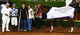 The winning connections of Talk Of The Bar accept the Juvenile Championship trophy at the Hipodromo de las Americas on Sunday.