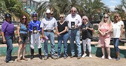 The winning connections of First Down Karma accept the Desert Classic Futurity stakes trophy at Turf Paradise.
