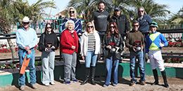 The winning connections of The Dulce Tacha accept the $27,800 Mark Villa Maiden Stakes trophy at Turf Paradise on Monday.