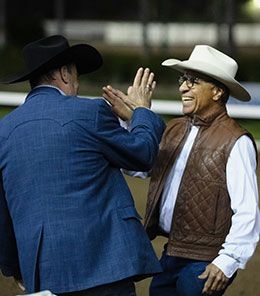 Trainer Marc Jungers (left) and Roman Figueroa congratulate each other at Los Alamitos Sunday night