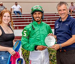 The winning connections of Doin It Just For Fun accept the Gentilly Stakes trophy at Fair Grounds Race Course.