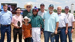 The winning connections of Drinkinatacartelbar accept the Jaguar Rocket Futurity stakes trophy.
