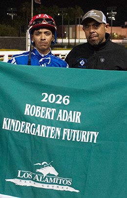 Jockey Jose Rosario Alcala and trainer Jose Flores with the Kindergarten winner's blanket.