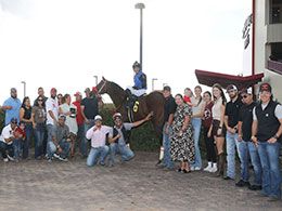 The winning connections of Volcoms Favorite accept the Lip Chip Albuquerque Distance Challenge stakes trophy on Saturday.