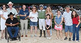 The winning connections of Jess Rite accept the Benny Pennington Memorial Stakes trophy.