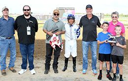 The winning connections of Tachas Secret accept the Horshoe Indianapolis Classic stakes trophy.