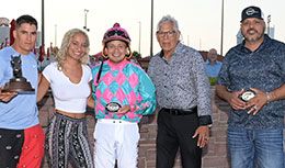 John Hernandez presents the winning connections of Rockin he Train the John Deere Prairie Meadows Juvenile Challenge stakes trophy.