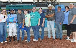 The winning connections of Chicks Cartell accept the Walter Merrick Stakes trophy Saturday evening.