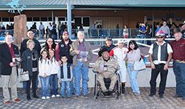 The winning connections of Pour Me A Drinkk accept the New Mexico Classic Quarter Horse Futurity stakes trophy at Zia Park.