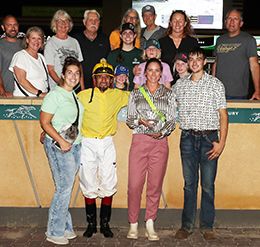 The winning connections of I D Claire accept the $15,000 Northlands Juvenile trophy at Canterbury Park on Thursday.