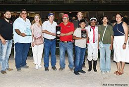 The winning connections of Eagles Up accept the Sire's Cup Derby stakes trophy on Saturday at Retama Park.