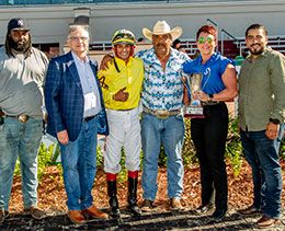 The winning connections of San Lorenzo Hustle accept the Big East Futurity stakes trophy at Fair Grounds Race Course.